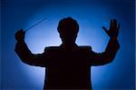 silhouette of conductor on blue background