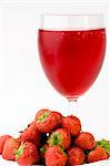 Fresh Strawberrys and glass of juice set against a plain background