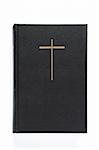 Black bible with cross on the cover isolated on white background