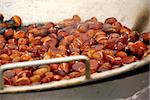 Chestnuts roasting in a pan at street vendor's stand