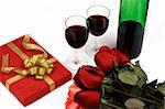 Rose with gift box and red wine.