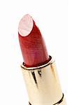 One tube of red lipstick. Macro shot (small DOF), with focus at front