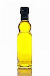 Extra virgin olive oil bottle reflected on white background