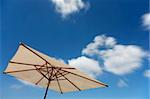 White Parasol with blue sky and clouds