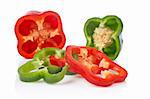 A fresh green and red pepper slices reflected on white background. Shallow DOF