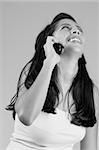 Happy  Hispanic girl talking on cell-phone