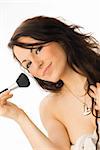 young and nice brunette doing make up with brush