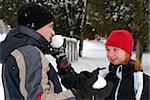 Father and child holding snowballs in winter park