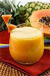 A glass of fresh pineapple papaya smoothie
