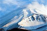 A dramatic close-up of snow covered Mount Fuji