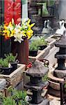 Pretty Asian garden with flowers and stone ornaments.