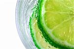 Green Lime in Soda Water with bubbles in glass