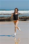 Athletic model running fast on the beach