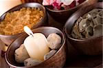 spa accessories: candles, scented stones, mud, body scrub, bath salt and rose petals