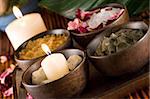 Spa accessories: candles, scented stones, mud, body scrub, bath salt and rose petals