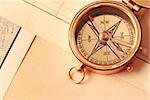 Antique brass compass over old map background