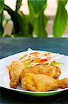 Fried chicken served with grated vegetables. Shallow DOF.