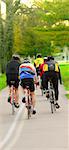 Group of bicyclist riding in a summer park