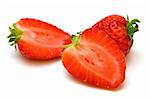 two halwes and whole strawberries on white background