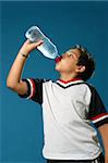 Thirsty boy drinking fresh water wearing sport clothes