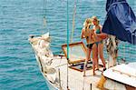 Two young girls are sailing on a yacht