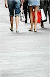 Two girls walking and going shopping in urban street