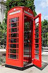 red telephone box with the door open along cannon street london