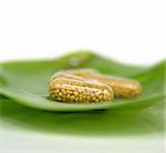 Some yellow pills on a green leaf - homeopathy