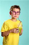 A boy sips a health juice containing nourishing wheatgrass, barleygrass and spirulina  through a crazy sipper straw