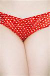 Close up of Caucasian young adult woman wearing polka dot underwear.