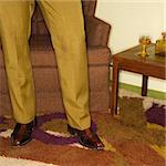 Close-up of standing Caucasian mid-adult male legs in vintage clothing.