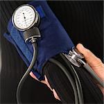 Close up of doctor testing blood pressure of patient.