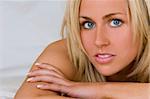 A stunningly beautiful young blond woman with bright blue eyes looking relaxed