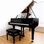 Grand Piano and stool on modern floorboards