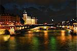 Bridges over Seine and Conciege in nighttime Paris France