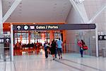 People walking towards gates at modern internation airport