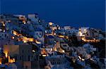 Image shows the village of Oia at dusk, on the beautiful island of Santorini, Greece