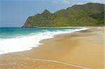 whitewash on tropical caribbean island with hill on the horizon