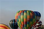 group of balloons lifting off in the misty sky