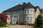 Exterior of a  large beautiful executive home under blue sky