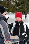 Father and child playing with snowballs in winter park