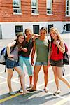 Portrait of a group of young smiling school girls in schoolyard