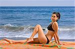 Teenager Latina female taking sunbath by sea
