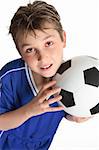 Boy holding a soccer ball ready to play