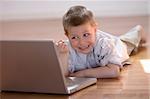 Child having fun with a computer at home