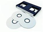 An image of a video tape and a DVD/CD, showing both old and new media technologies.