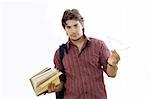 Male student holding books and reading glasses - isolated over white