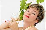 Woman in a formal dress enjoying a glass of wine