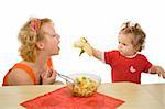 Baby girl feeding her mother with banana - healthy eating concept - isolated