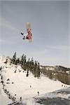 Daring snowboardrider taking off and grabbing at the Artic Challenge in Oslo